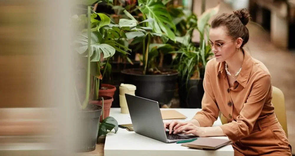 Young contemporary female owner of small business working in the internet